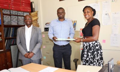 The Dean School of Statistics and Planning (SSP) Dr. James Wokadala (L) witnesses as outgoing Head of the Department of Population Studies, Dr. Stephen Ojiambo Wandera (C) hands over to incoming Head, Dr. Patricia Ndugga on 1st July 2022, CoBAMS, Makerere University.