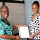 Dr. Evelyn Kigozi Kahiigi (L) handing over the report to Dr. Fiona Tulinayo Penlope (R) in the Office of the Head, Department of Information Technology on 27th July 2022, CoCIS Block A, Makerere University.