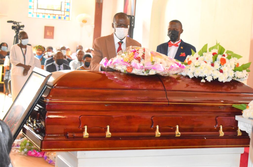 The Principal CoVAB, Prof. Frank Norbert Mwiine lays a wreath on the Late Prof. Christine Dramzoa's casket during a requiem mass at St. Augustine Chapel on Friday 1st July 2022