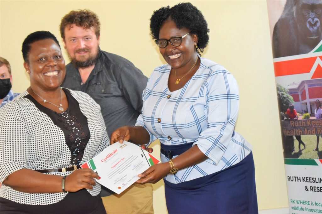Dr. Claire Mugasa (Right) hands over certificates to participants at the close of the Boma.