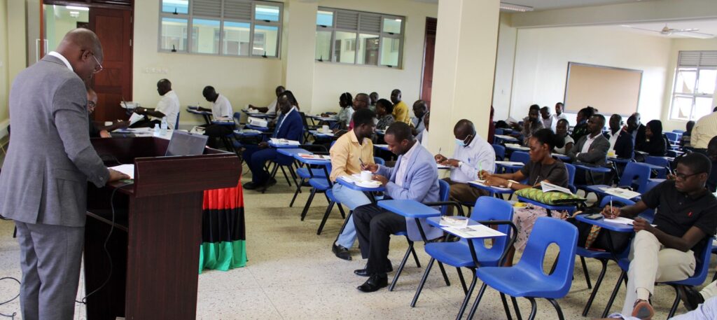 Prof. Edward Bbaale speaking as participants listen.