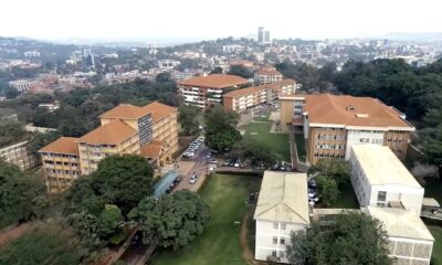 An aerial view of Left to Right: Mitchell Hall, Senate, CoCIS Blocks B and A, Lincoln Flats, Frank Kalimuzo Central Teaching Facility and School of Social Sciences (white) Buildings, Makerere University, with Kampala City in the background, October 2018. Uganda.
