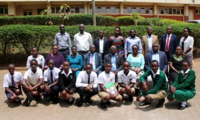 Dr. Wandera Stephen (Seated 2nd R), Dr. Rebecca Nambi (Seated 3rd R) and other officials with students from Mityana SS and Nakanyonyi SS at the research dissemination on 10th August 2022, Yusuf Lule Central Teaching Facility, Makerere University.