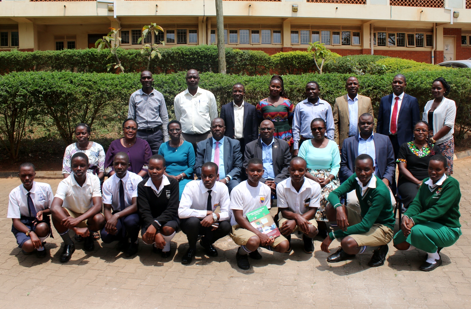 Dr. Wandera Stephen (Seated 2nd R), Dr. Rebecca Nambi (Seated 3rd R) and other officials with students from Mityana SS and Nakanyonyi SS at the research dissemination on 10th August 2022, Yusuf Lule Central Teaching Facility, Makerere University.