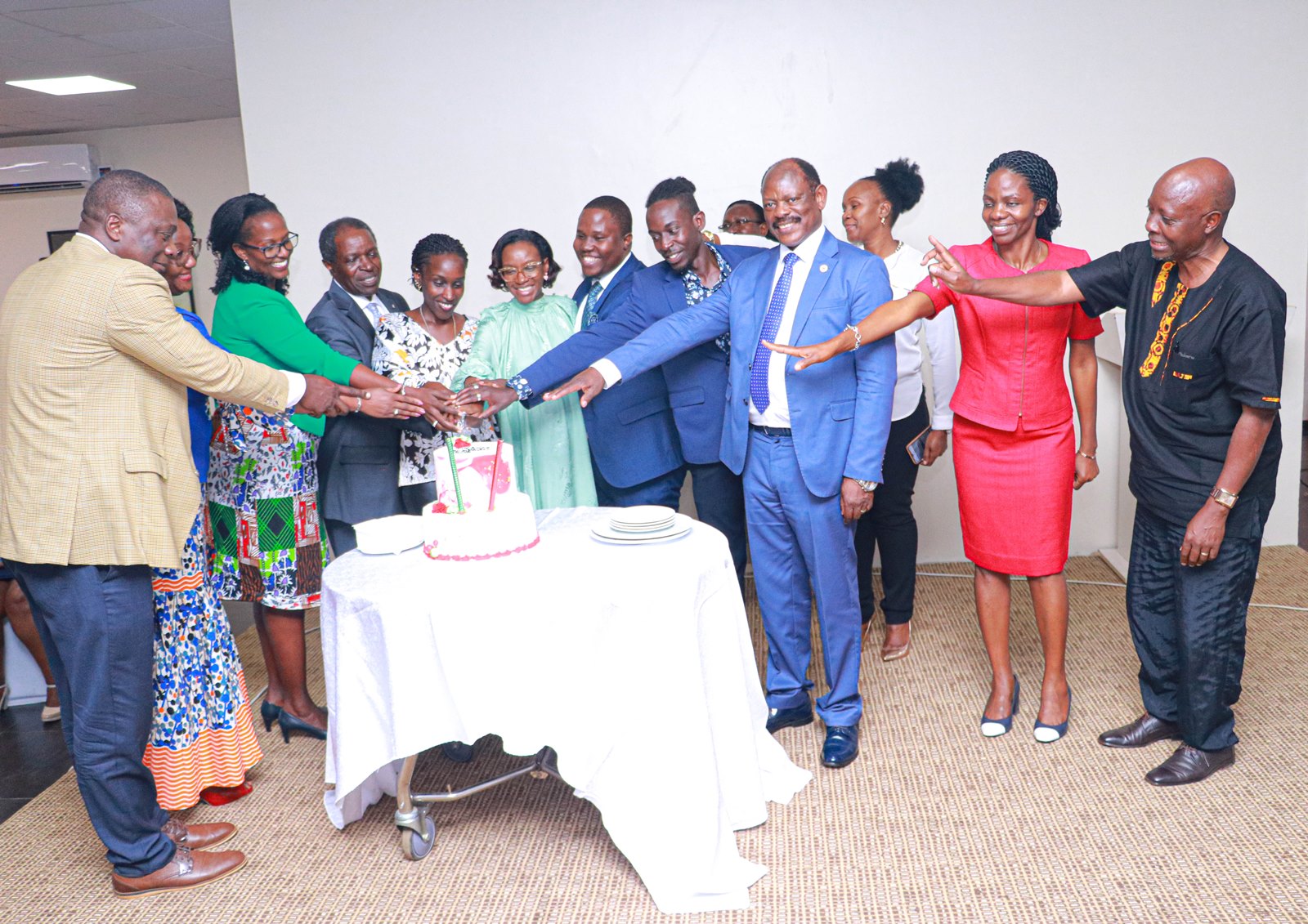 Professor William Bazeyo (4th L) cuts cake alongside the Chair Council-Mrs. Lorna Magara (3rd L), Vice Chancellor-Prof. Barnabas Nawangwe (3rd R), his family, CHS and MakSPH leadership on 9th August 2022.