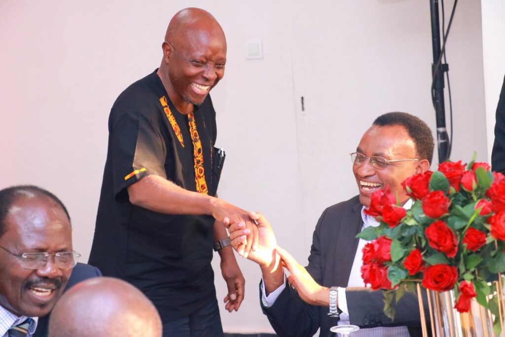 Associate Prof. John C. Ssempebwa, a former Head of Department of Disease Control and Environmental Health (Standing) with Prof. Elizeus Rutebemberwa (Right).