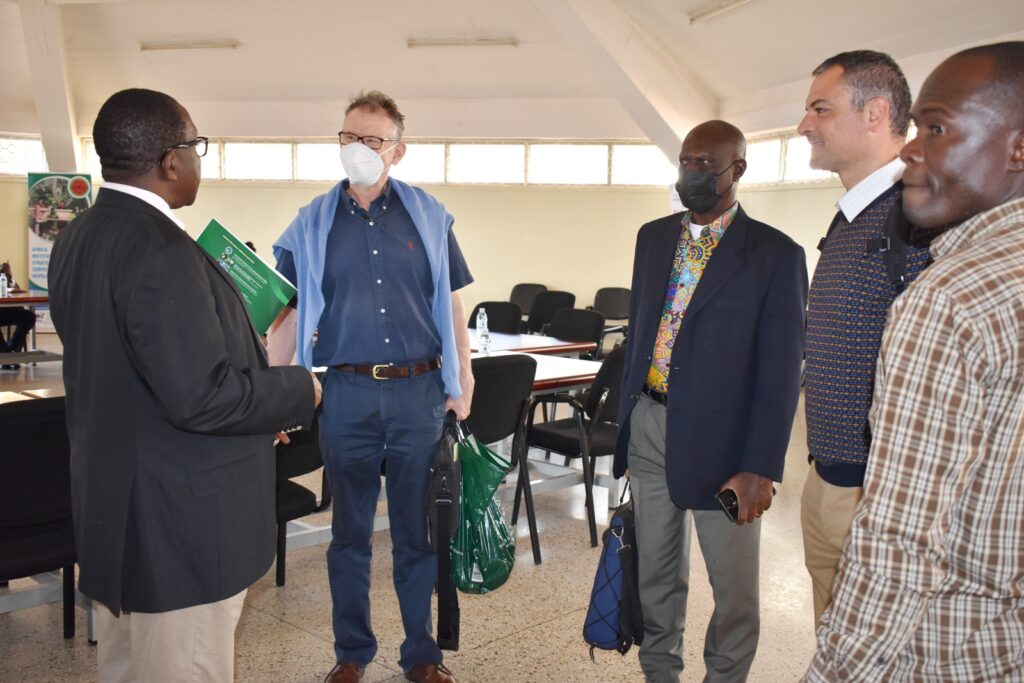 Prof. John David Kabasa (L) chats with stakeholders at the symposium.