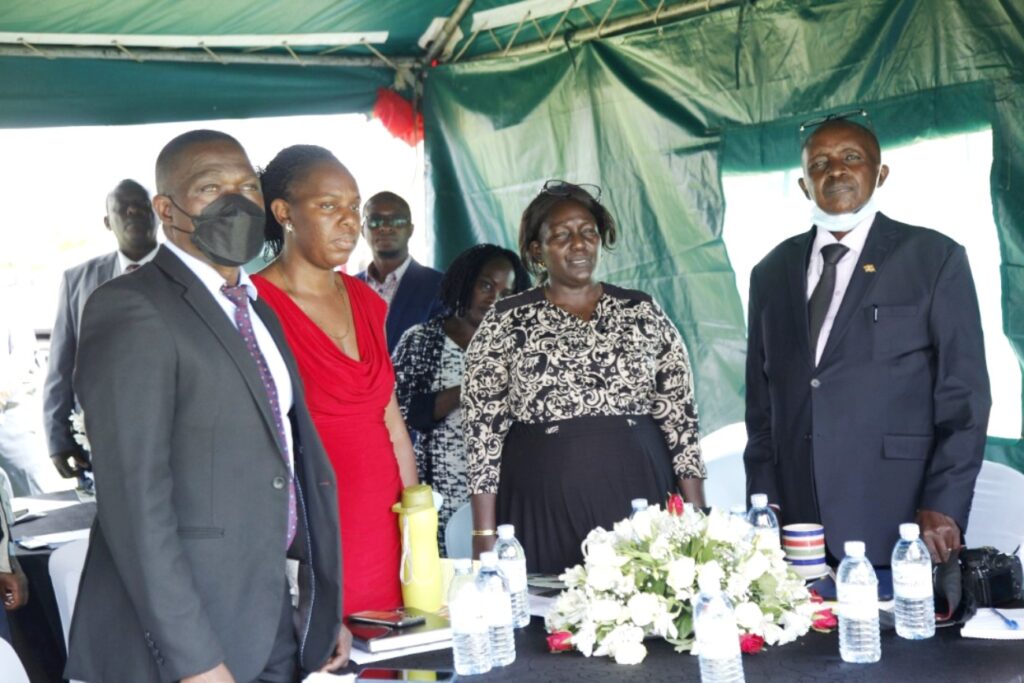 Dr. Michael Kansiime (R), Ms. Consolata Acayo (2nd R), Dr. Daniel Kasibule (L) and another official at the event.