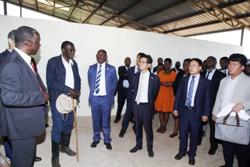 Prof. Robert Tweyongyere (L) explains some of the facility's operations to officials during the tour.