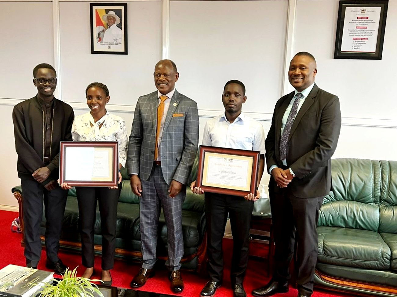 The Vice Chancellor-Professor Barnabas Nawangwe (Centre) with Mak Moot Society Patron-Dr. Daniel Ruhweza (Right), SoL Alumni & Team Coach-Mr. David Kasibante (Left) and winners: Ms. Kevin Nakimbugwe (2nd Left) and Mr. Edwin Sabiiti (2nd Right) with their certificates of recognition on 4th August 2022, Frank Kalimuzo Central Teaching Facility, Makerere University.