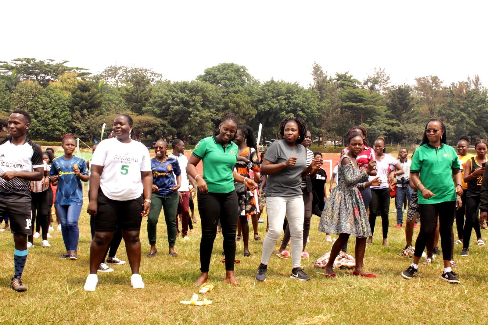 Prof. Sarah Ssali (R) together with other participants doing zumba dance, one of the activities at the launch of the Scholars Program Community Open Day on 30th July 2022, Rugby Grounds, Makerere University.