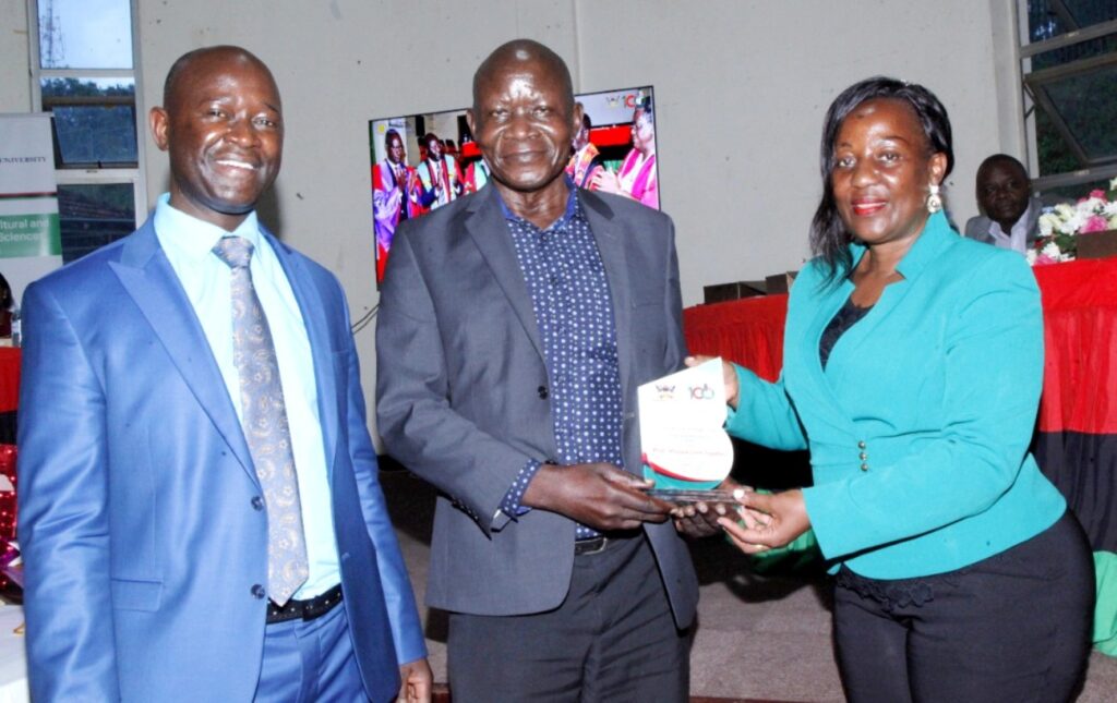Retired member of staff, Prof. John Steven Tenywa receiving an award from the Principal CAES. On the Left is the Deputy Principal, Prof. Yazidhi Bamutaze.