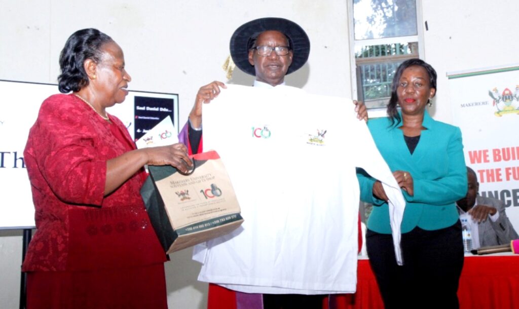 CAES Principal presents a souvenir to Prof. Sabiiti. On the Left is Mrs. Joy Sabiiti.