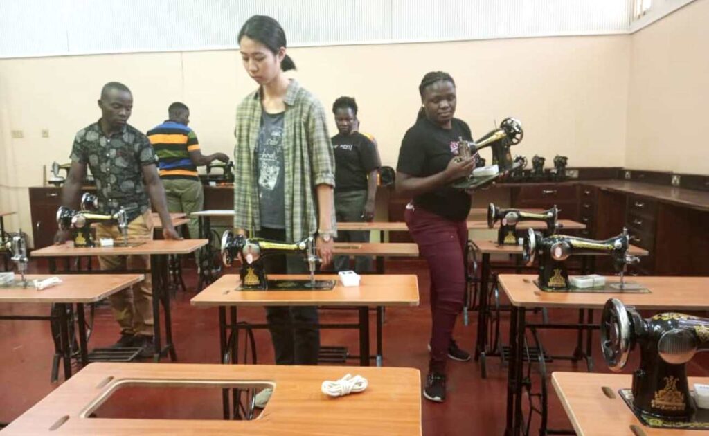 Staff of Makerere and Love Binti International Assemble the sowing machines.