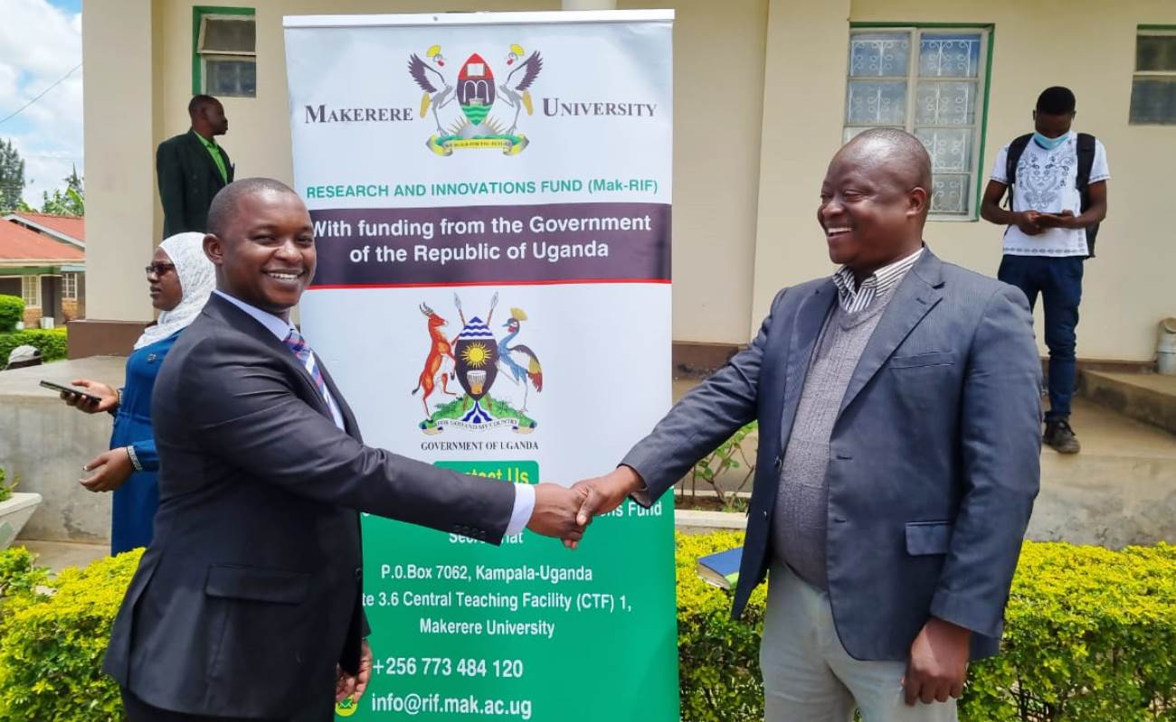 Dr. Kasimu Sendawula (L) shakes hands with one of the officials after the research dissemination workshop at St. Joseph’s Inn Virika-Fort Portal on 29th September 2022.