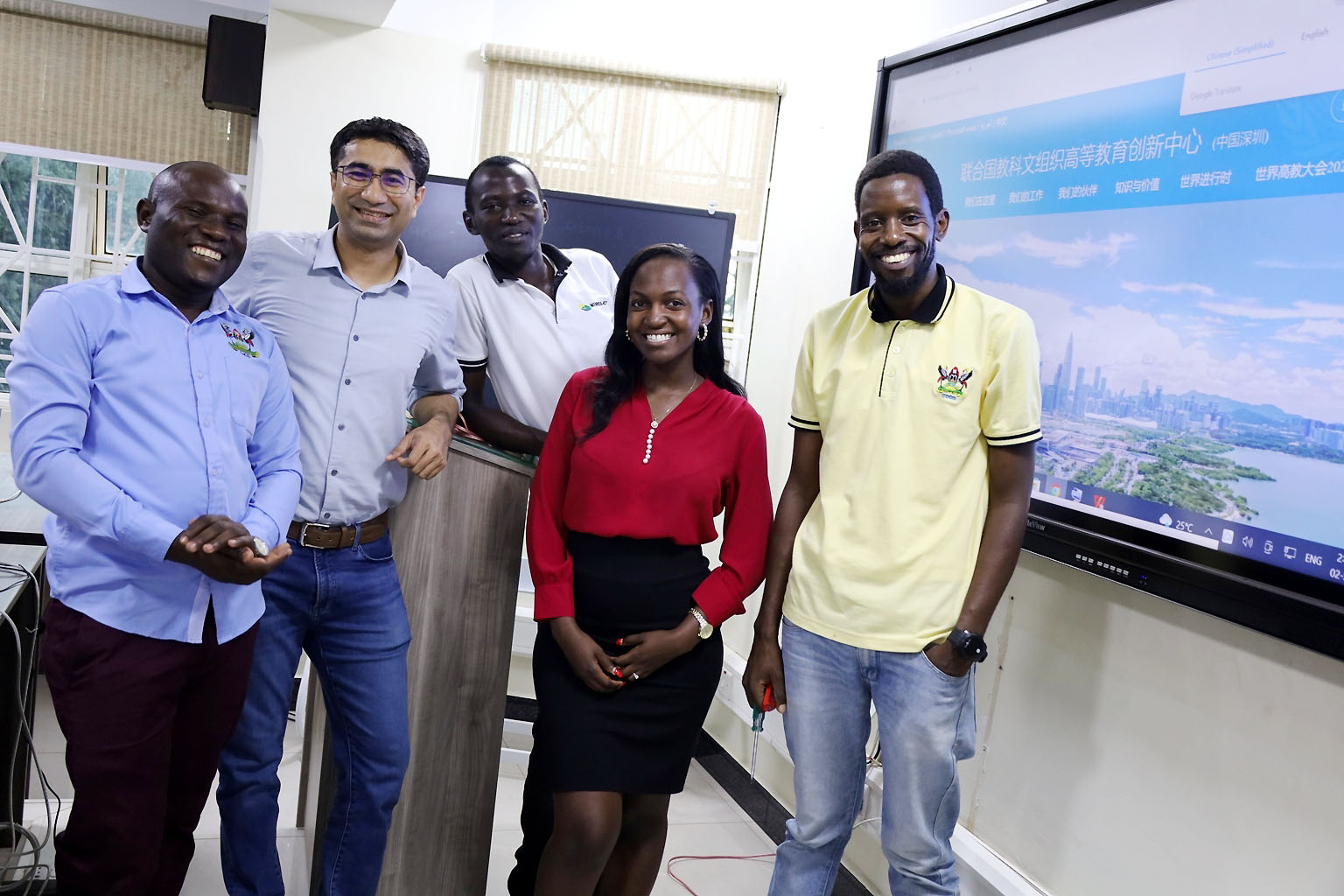 The team of IT experts that helped set up the Smart Classrom L-R: Baluku Herbert, Hassan Adeel, Badru Ssekumba, Claire Wessaali and Nicholas Betungye pose for a group photo after the successful test on 2nd September 2022, CoCIS, Makerere University.