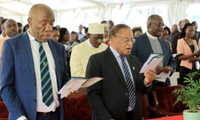 The Chancellor, Prof. Ezra Suruma (R) and DVCFA, Prof. Henry Alinaitwe (L) join the congregation in song during the Makerere@100 National Thanksgiving Prayer, 2nd September 2022, Freedom Square, Makerere University.