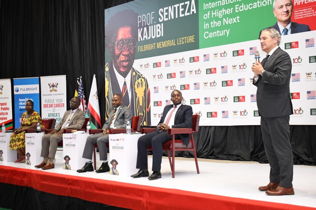 Dr. Michael Pippenger (R) joins members of the Panel on stage during the interaction with the audience at the Prof. Senteza Kajubi Fulbright Memorial Lecture. 