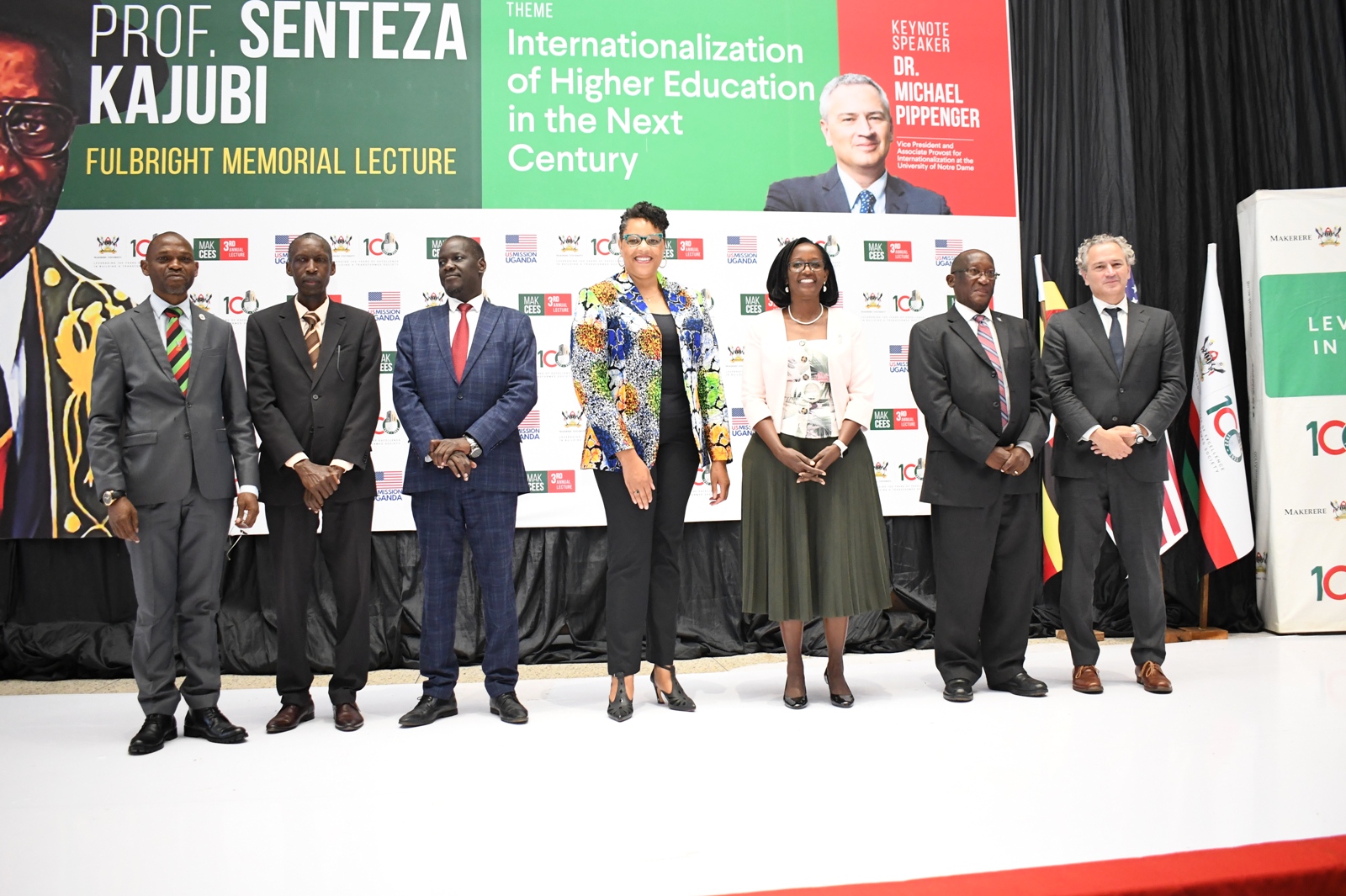 H.E. Natalie Brown (C) flanked by the Chairperson of Council-Mrs. Lorna Magara (3rd R) and Deputy Chairperson-Rt. Hon. Daniel Kidega (3rd L) and L-R: DVCAA-Prof. Umar Kakumba, Prof. Anthony Muwagga Mugagga, Mr. Wasswa Kajubi and Dr. Michael Pippenger at the Memorial Lecture on 22nd Sept 2022, Yusuf Lule Central Teaching Facility Auditorium, Makerere University.