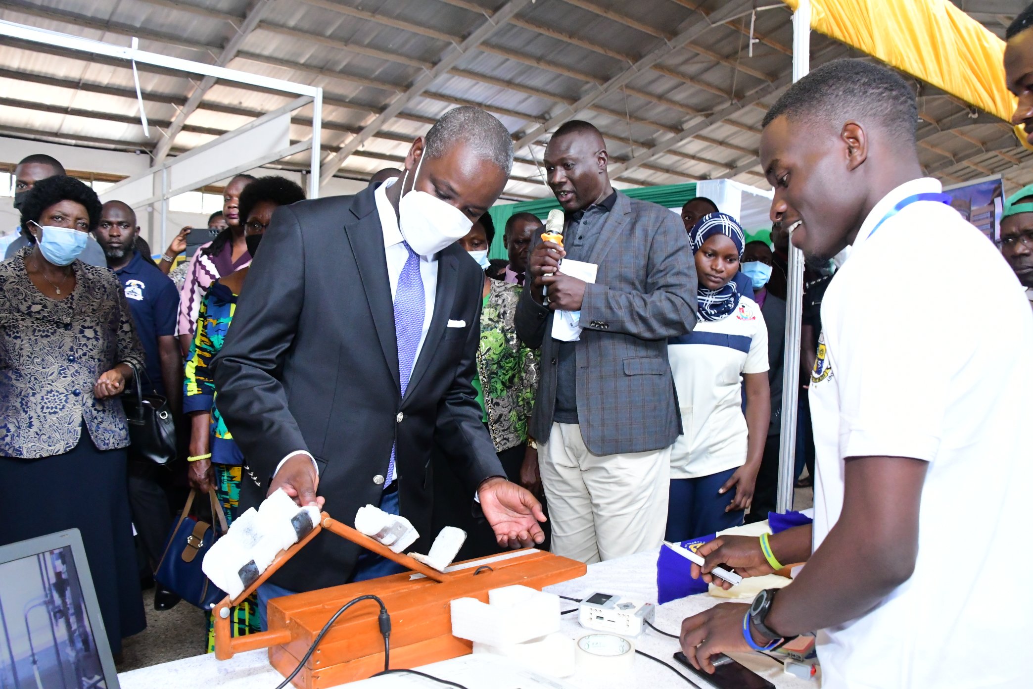 The Deputy Speaker of Parliament, Rt. Hon. Thomas Tayebwa inspects one of the innovations at the 13th Blended Higher Education Institutions Exhibition on 22nd September 2022. Courtesy Photo: Twitter/@Thomas_Tayebwa