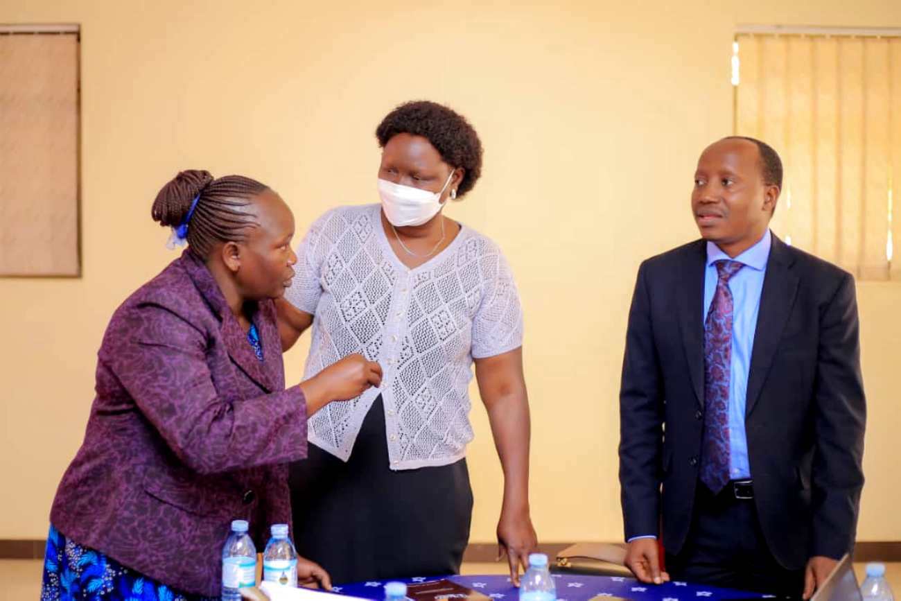 The Director of Culture at the Ministry of Gender, Labour and Social Development, Ms. Juliana Naumo Akoryo (Centre) and Dr. Godfrey Siu, the Principal Investigator from Mak-CHDC (Right) interact with a participant at the workshop on 22nd July 2022, Kampala.