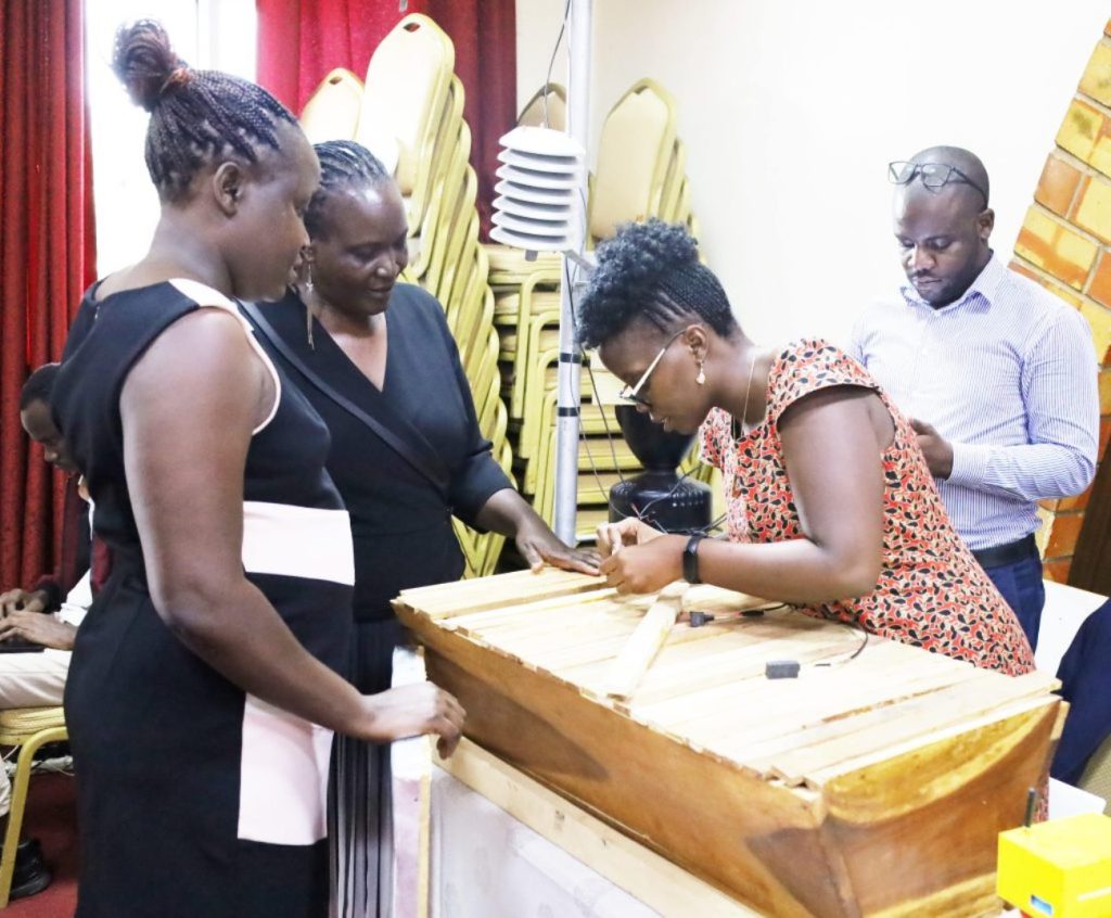 Dr. Agatha Turyagyenda explaining the technology to some of the conference participants.