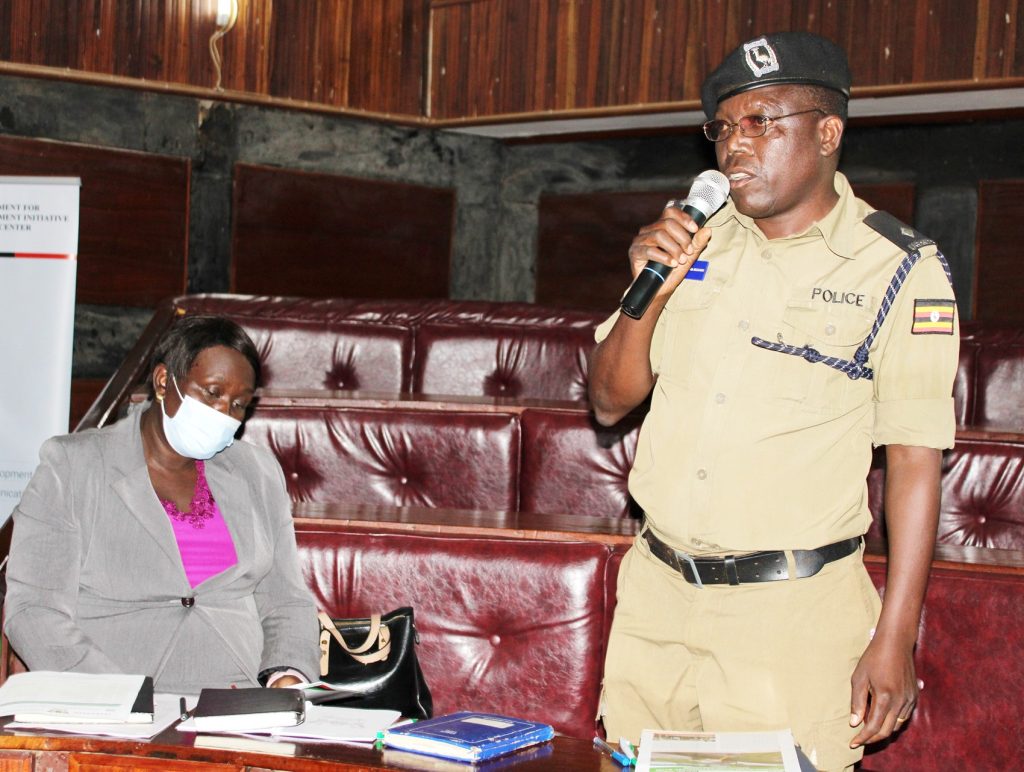 The Deputy RDC Maria Lubega (Left) listens as the District Police Officer contributes.