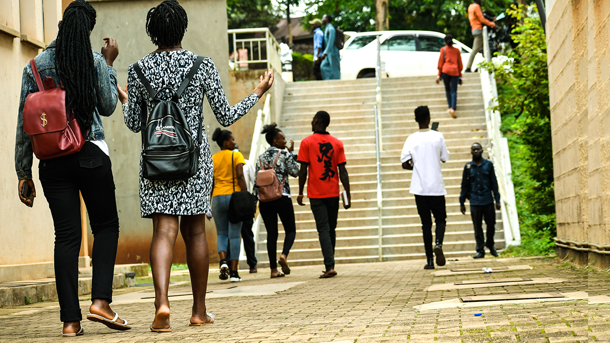 Students stroll past the Frank Kalimuzo Central Teaching Facility-CTF (Left) and School of Social Sciences (Right) on the Makerere University Main Campus. Kampala Uganda, East Africa.