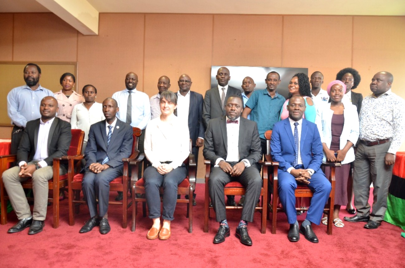 The University Secretary-Mr. Yusuf Kiranda (2nd Right) with Left to Right: Mr. John Mary Kisembo, Principal CEES-Prof. Antony Mugagga Muwagga, JRS Country Representative Ms. Christina Zetlemeisl and Dean School of Education-Assoc. Prof. Mathias Mulumba Bwanika with other officials (standing) at the event on 1st December 2022, Makerere University.