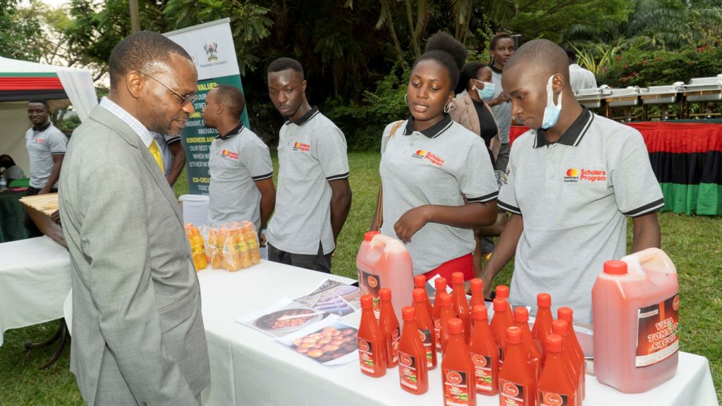 Prof. Kakumba inspecting some of the products produced by Scholars.