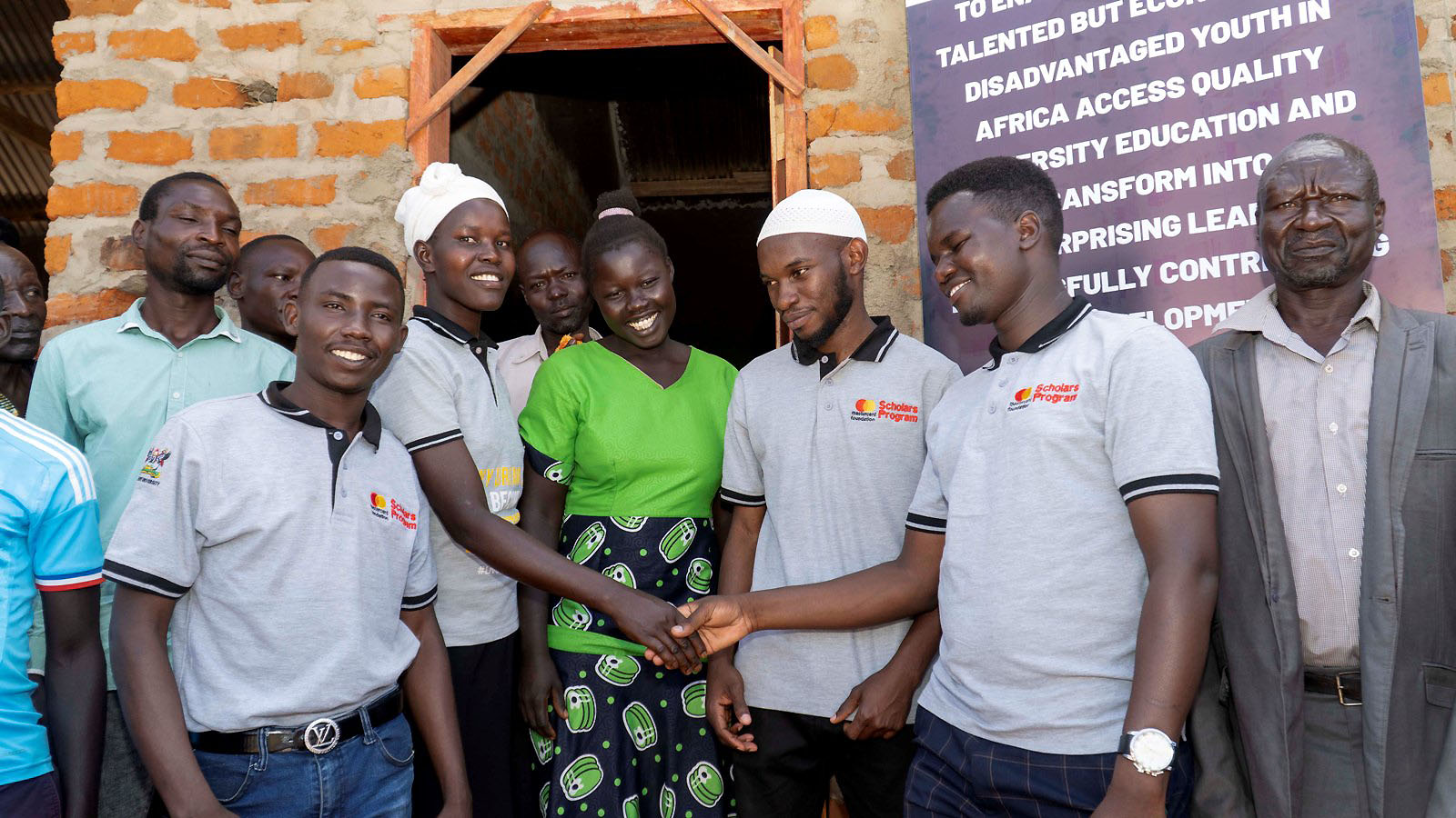 Mr. Batte, the Scholars Council Representative with a (muslim skulll cap) together with Ms. Betty Angom (in green attire) the Head teacher of St. Catherine primary School at the launch on 3rd December 2022 in Okudu-Teyaa Village, Adilang sub-county, Agago district.