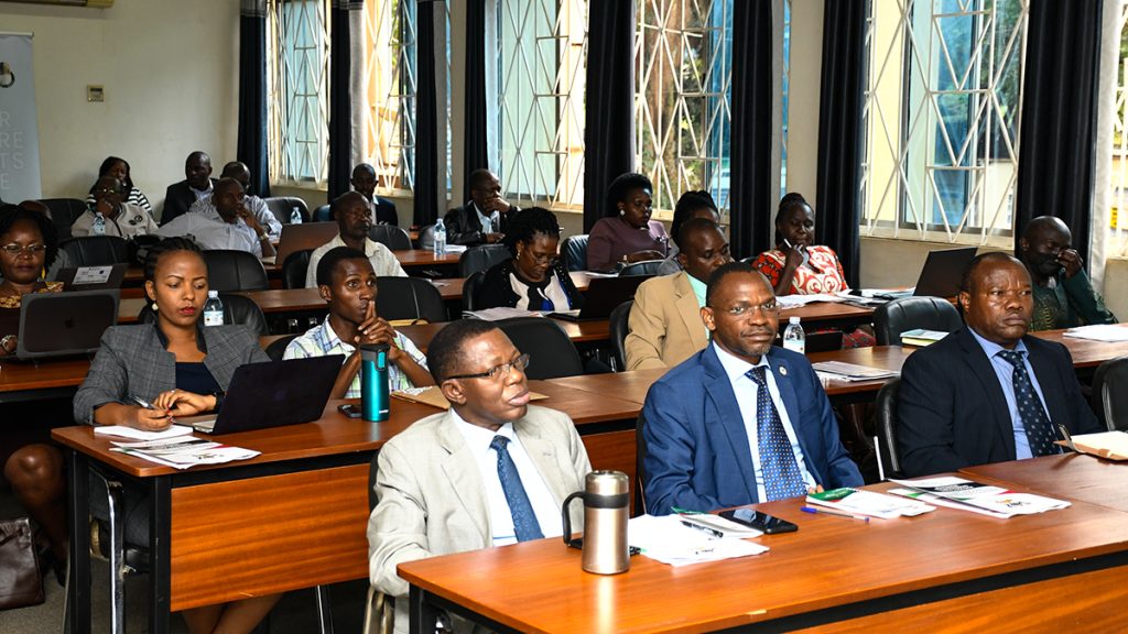 Front Row: Prof. Umar Kakumba (C), flanked by Prof. Buyinza Mukadasi (L) and Prof. Edward Mwavu (R) listen to proceedings during the SECA Final Dissemination Workshop. 