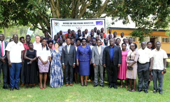 The Minister of State for Northern Uganda, Hon. Grace Freedom Kwiyuchiny (c), the representative of Makerere University Vice Chancellor, Prof. Buyinza Mukadasi (6th R) and the representative of the Head of the EU Delegation in Uganda (4th L) with some of the trained extension workers at the closing ceremony.