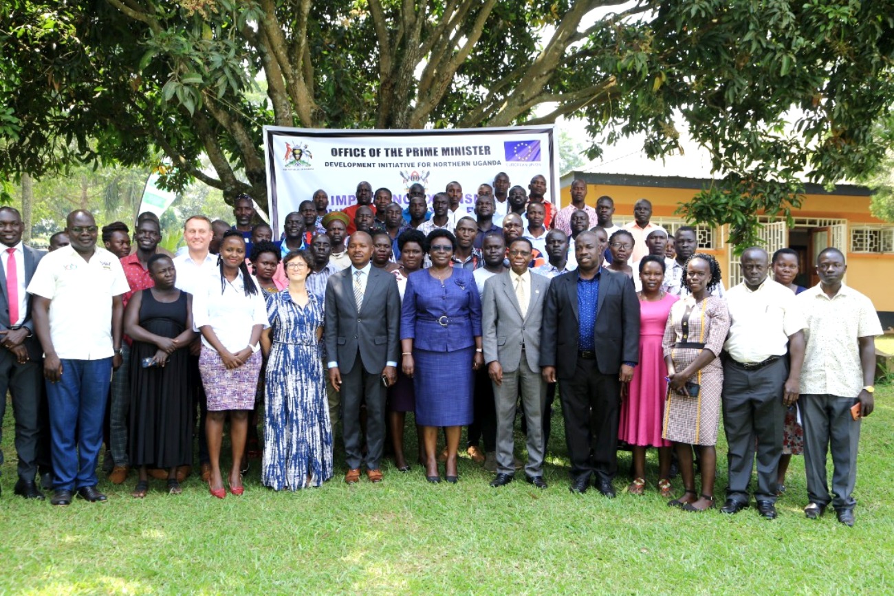 The Minister of State for Northern Uganda, Hon. Grace Freedom Kwiyuchiny (c), the representative of Makerere University Vice Chancellor, Prof. Buyinza Mukadasi (6th R) and the representative of the Head of the EU Delegation in Uganda (4th L) with some of the trained extension workers at the closing ceremony.