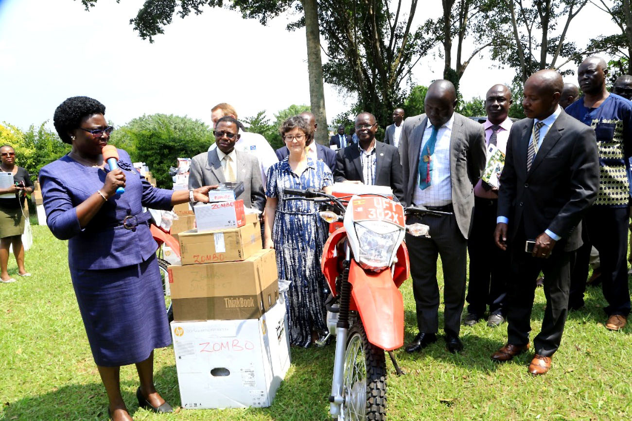 Hon. Grace Freedom Kwiyucwiny (L) hands over some of the donated items to the district officials as Prof. Buyinza Mukadasi (2nd L) and other officials witness on 27th January 2023 at CAEC, MUARIK, Makerere University.