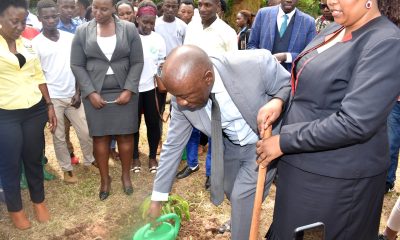 Prof. Henry Alinaitwe (2nd Right) plants a tree to signify the launch of the 30-acre CAES Botanical Gardens at the Makerere University Agricultural Research Institute Kabanyolo (MUARIK) on 6th December 2022 as Hon. Kaaya Christine Nakimwero (Right), Prof. Gorettie Nabanoga (Left) and other officials as well as students witness.