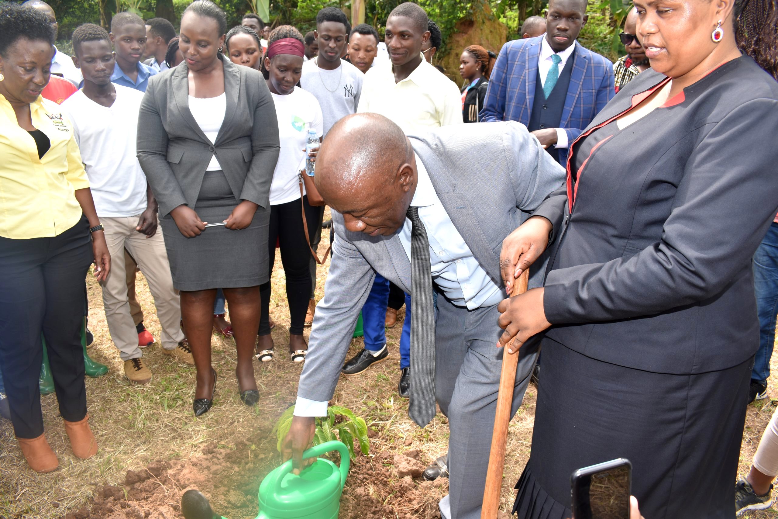 Prof. Henry Alinaitwe (2nd Right) plants a tree to signify the launch of the 30-acre CAES Botanical Gardens at the Makerere University Agricultural Research Institute Kabanyolo (MUARIK) on 6th December 2022 as Hon. Kaaya Christine Nakimwero (Right), Prof. Gorettie Nabanoga (Left) and other officials as well as students witness.