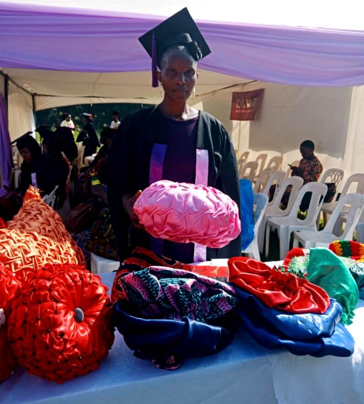 A graduand poses with some of her products.