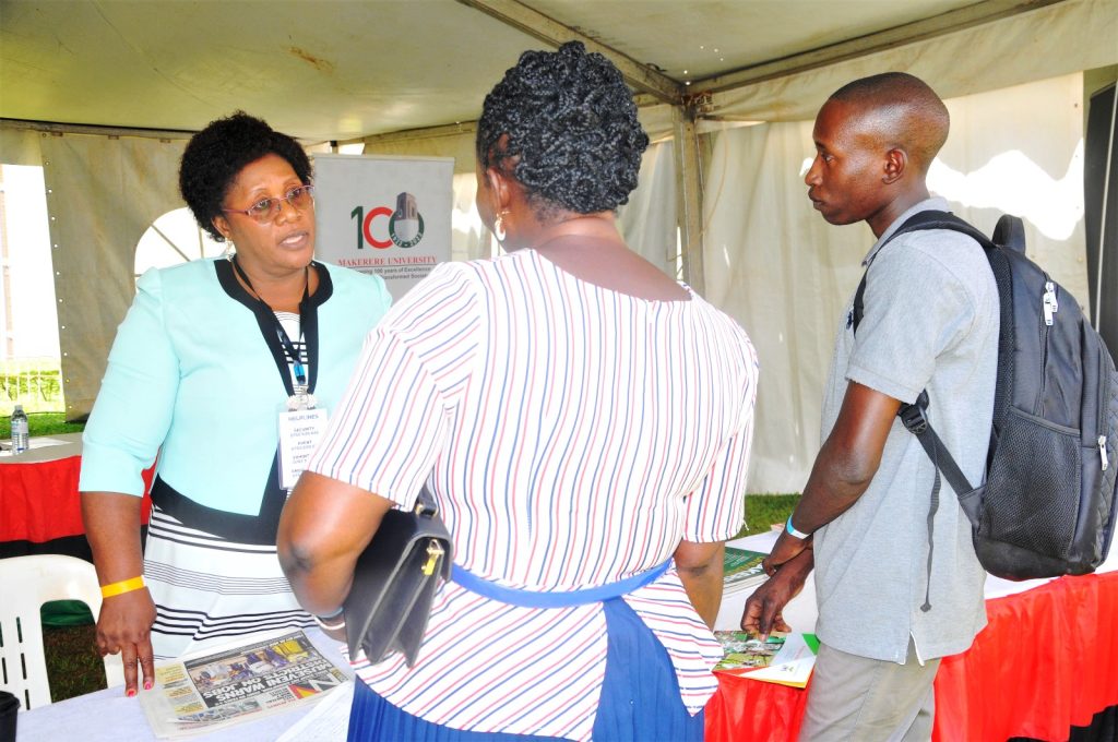 Ms Joyce Muhanguzi, has a one-on-one session with visitors to the Makerere University exhibition space. 