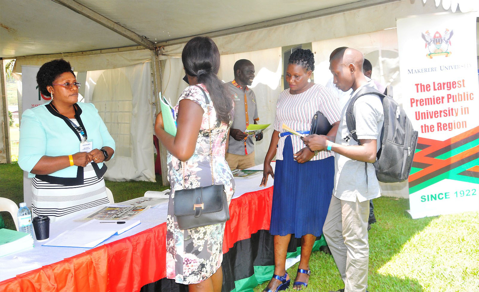 Ms Joyce Muhanguzi, Senior Assistant Registrar in the Department of the Academic Registrar (L) interacts with visitors during the New Vision Education Expo 2023.