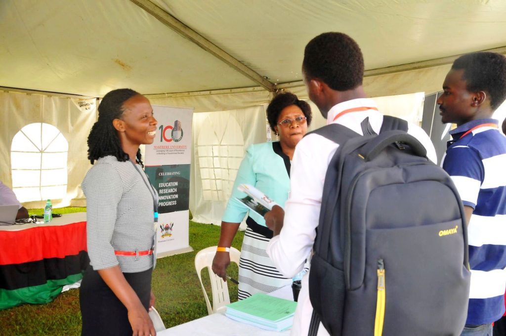 Ms. Ritah Namisango (L) and Ms. Joyce Muhanguzi interact with members of the public. 