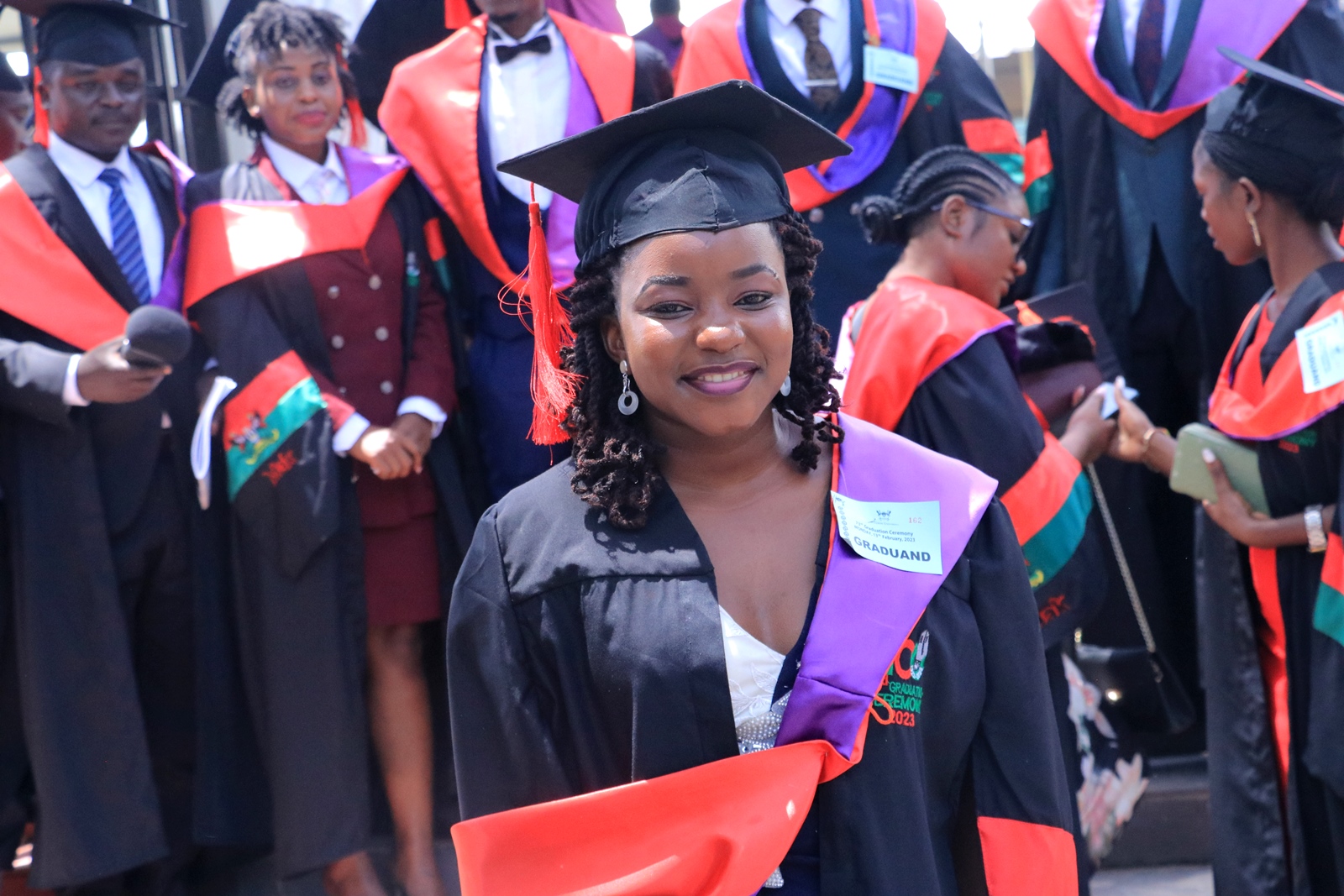 Carol Esther Nabbanja, the best performing MakSPH student for the 73rd Graduation smiles for the camera shortly before being conferred upon her degree on 13th February 2023 at the Freedom Square, Makerere University, Kampala Uganda, East Africa.