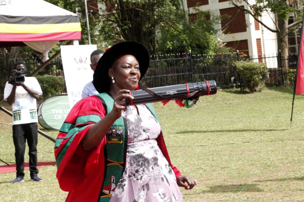 Another female graduate from CAES jubilates after receiving her PhD.