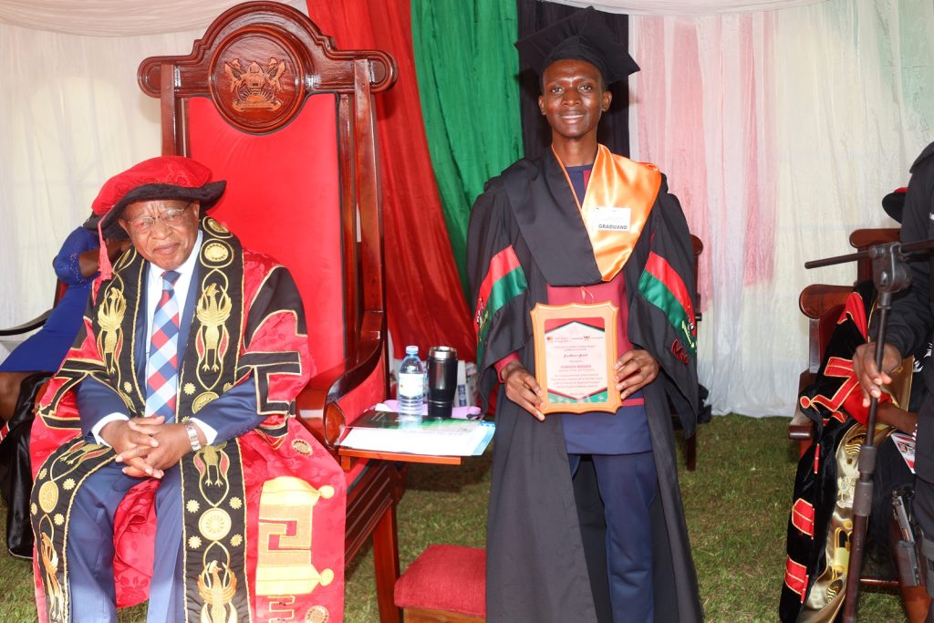 The Chancellor, Prof. Ezra Suruma (L) with one of the Mastercard Foundation Scholars Program beneficiaries Mr. Kawooya Rodgers who got a First Class degree.