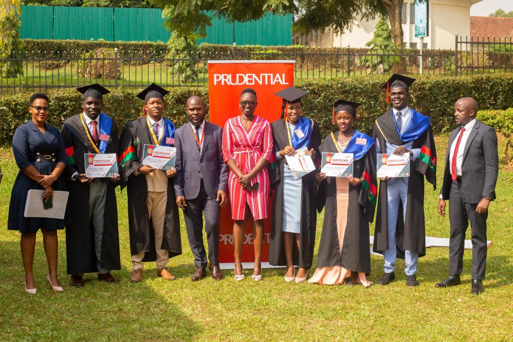 Top 5 Actuarial Science students; Mukiibi Cyrus (2nd L), Mwesigwa Mark Lewis (3rd L), Nanfuka Rebecca Rosette (4th R), Akumu Gloria Agnes (3rd R) and Angura Kupa Abraham (2nd R) with the team from  Prudential Uganda. 