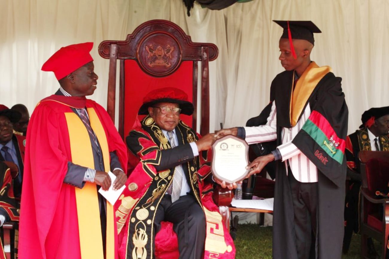 Sanga Arnold Lukoda from CoCIS who emerged the overall best science student for the Mak 73rd Graduation ceremony with a CGPA of 4.85 out of 5.0 receiving a plaque from the Chancellor Prof. Ezra Suruma on Day 3 of the 73rd Graduation Ceremony, 15th February 2023.