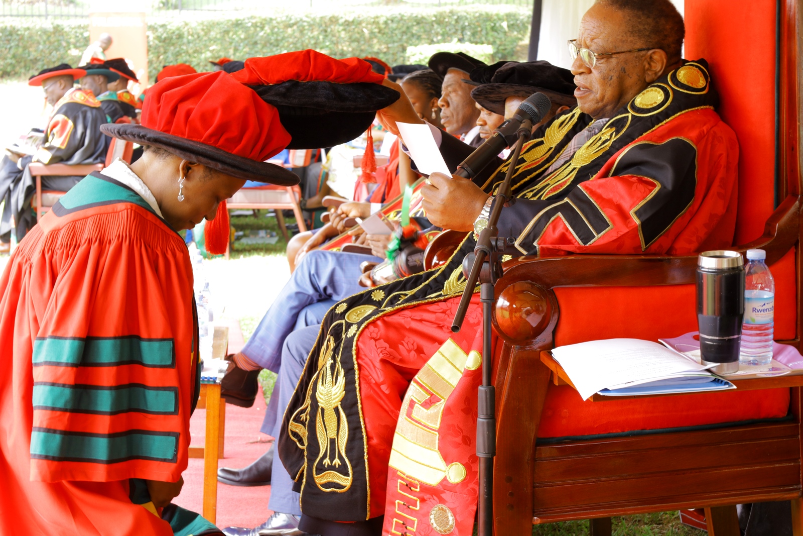 Prof. Ezra Suruma conferring a PhD upon one the female candidates on Day 3 of the 73rd Graduation Ceremony, 15th February 2023. Freedom Square, Makerere University, Kampala Uganda, East Africa.