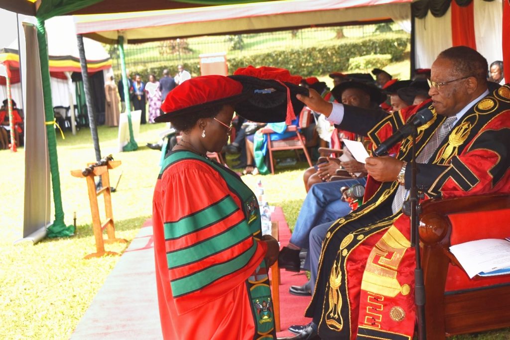 The Chancellor, Prof. Ezra Suruma confers a Doctorate Degree upon Dr. Nabulime Margaret during the 73rd graduation ceremony.