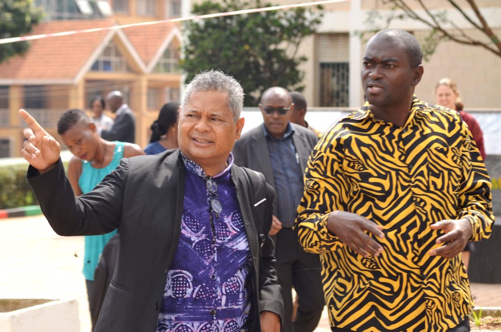 Prof. André Keet (L) and Dr. Jude Ssempebwa (R) chat as they take in the sights around the Makerere@100 Monument.