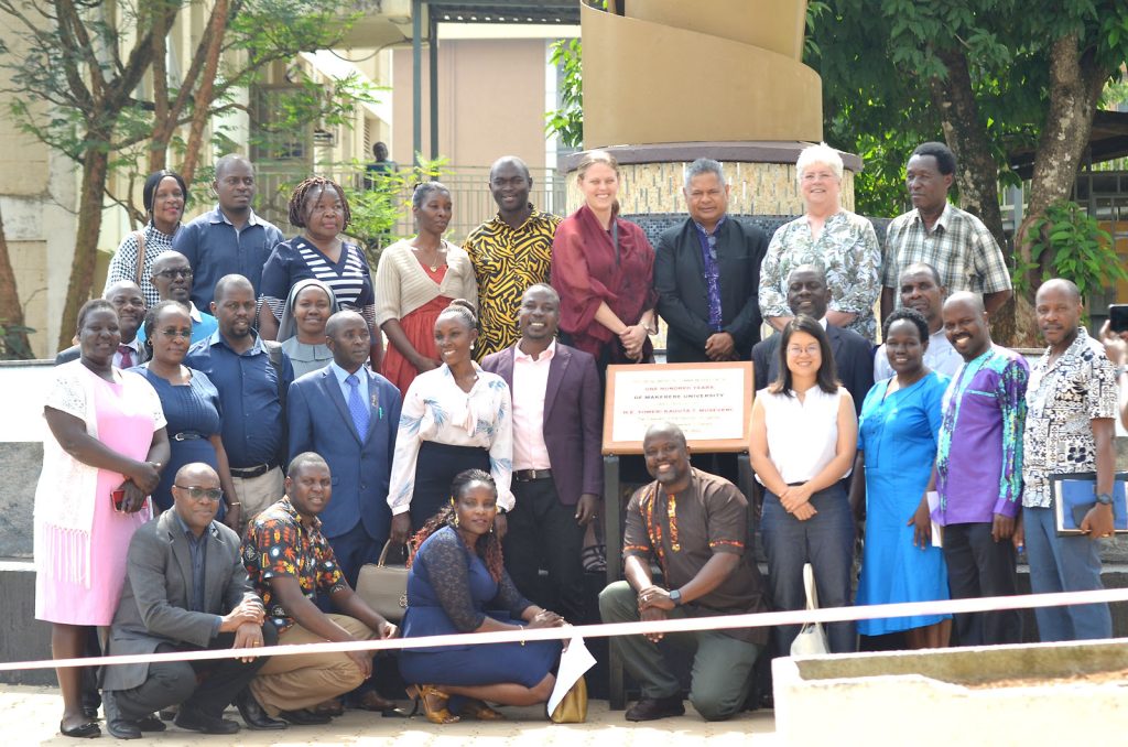 Prof. André Keet poses for a group photo with participants at the Makerere@100 Monument after the public lecture.